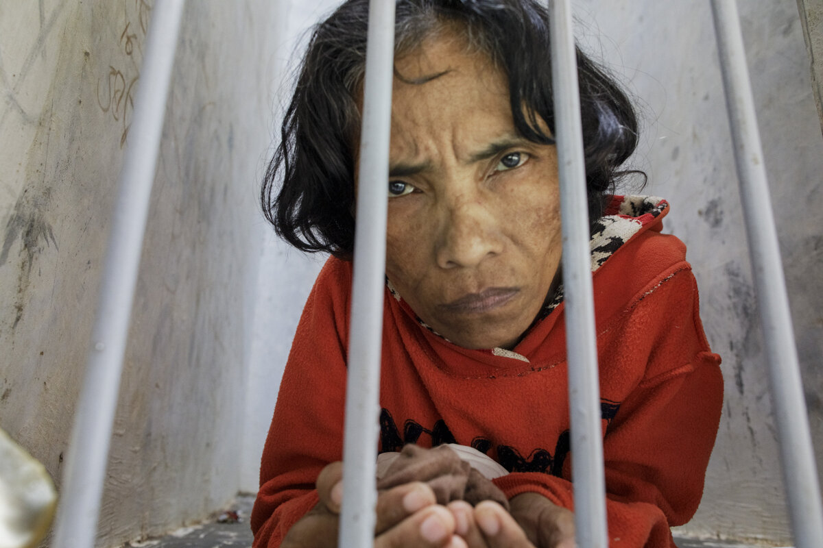"A woman with a psychosocial disability lives confined in a bare narrow cell at madrasah Ar-Ridwan, a private Islamic healing center in Cilacap, Central Java, Indonesia. Photo: © 2019 Andrea Star Reese